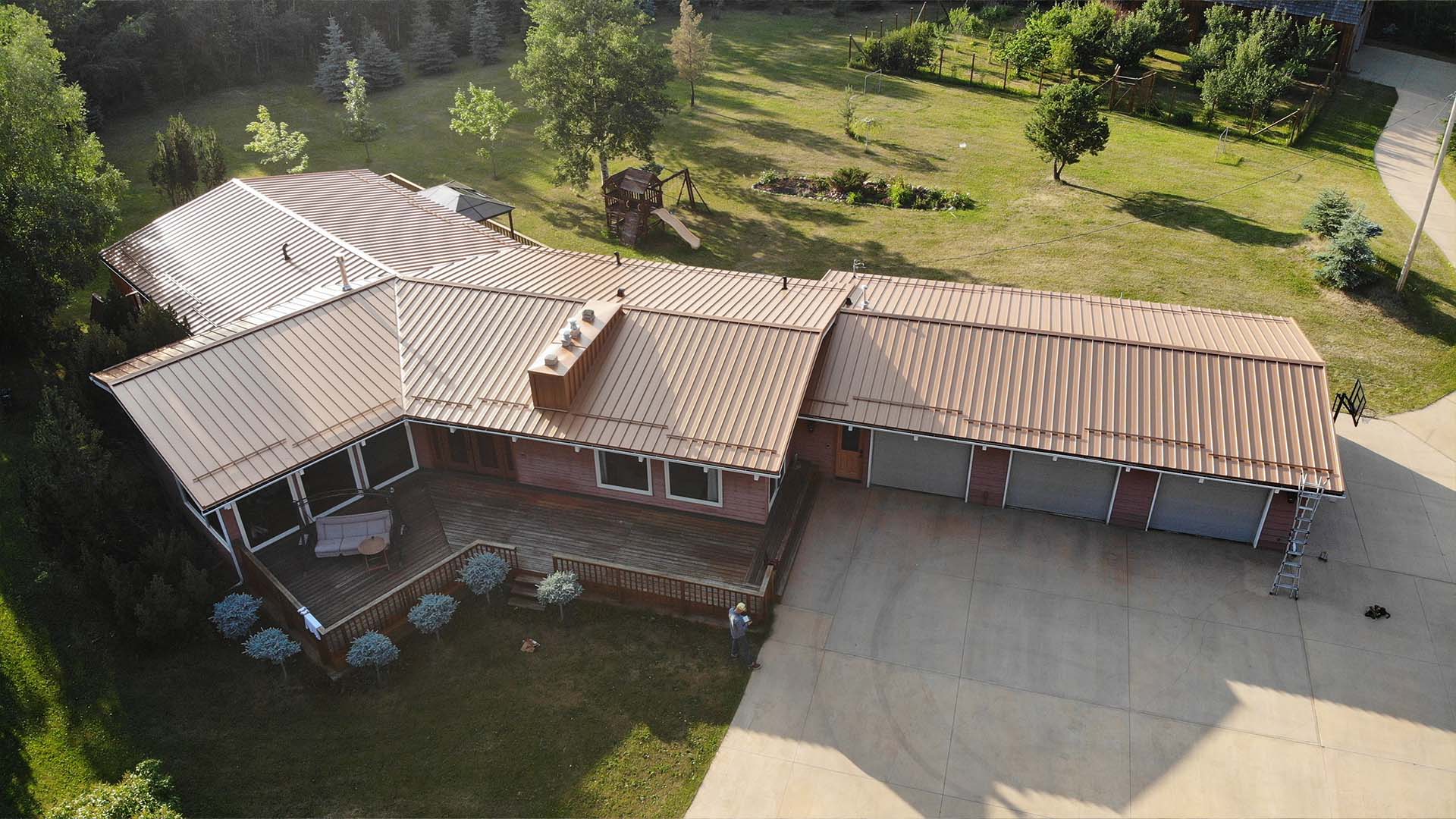 Standing seam metal roof in copper penny finish — IronWrap install